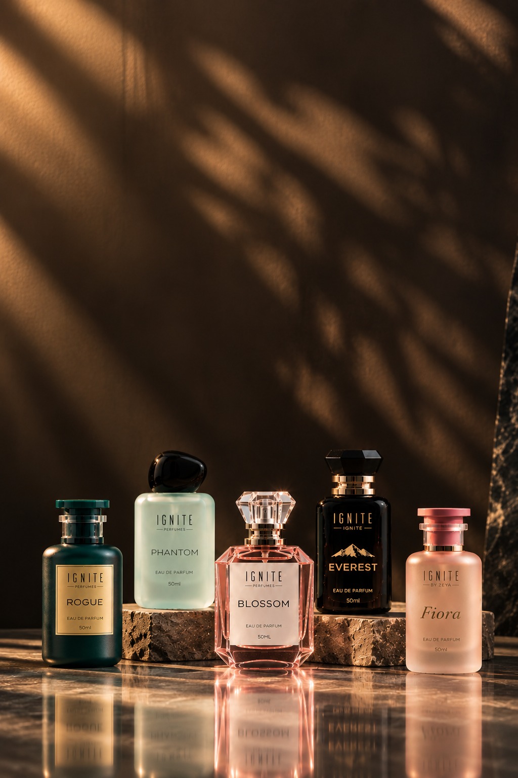 Ignite perfume bottles — Rogue, Phantom, Blossom, Everest, and Fiora — arranged on stone
